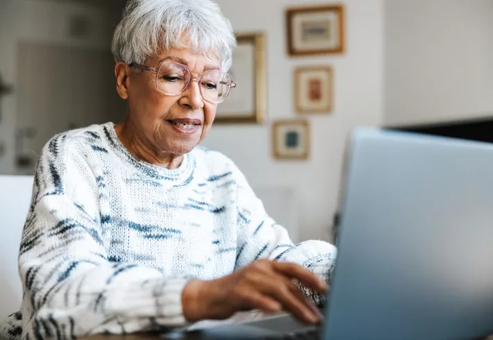 Senior woman using a laptop at home. 