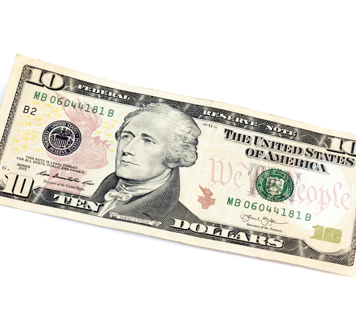 A ten dollar bill on a white background. 