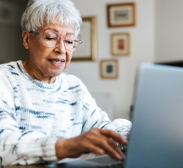 Senior woman using a laptop at home. 