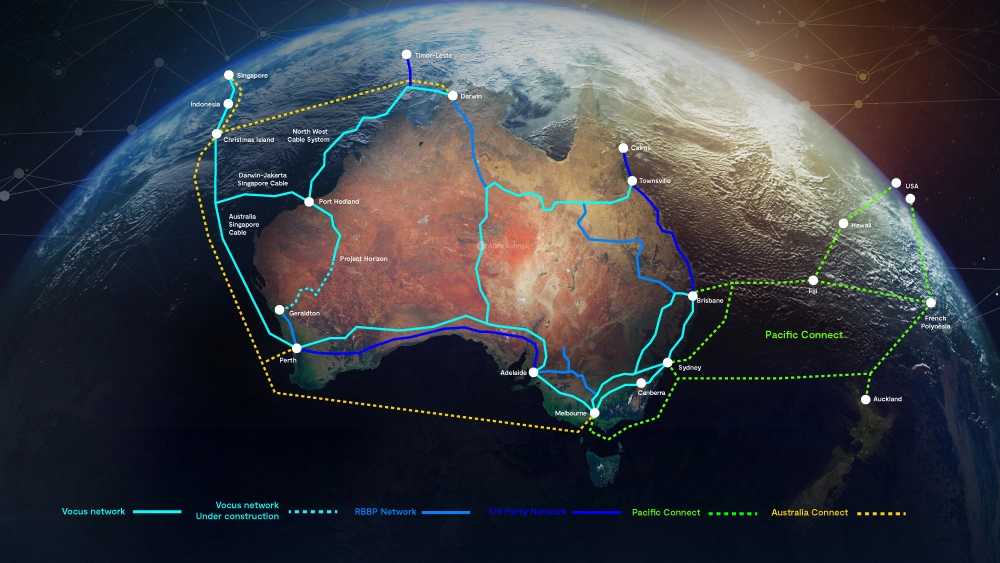 The image shows a map of Australia with various colored lines representing different submarine cable routes connecting Australia to other regions such as Asia and the Pacific Islands. The cables are labeled with names like "ASC," "JGA-S," "Coral Sea Cable System," and others. The image also includes logos for Vocus and Google, indicating their involvement in these cable systems. This highlights the infrastructure that supports internet connectivity and data transmission across vast distances, which is crucial for global communication and digital services.