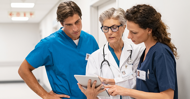 healthcare-team-evaluating-patient-data-in-hallway.jpg