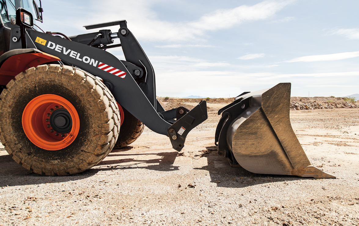 DEVELON wheel loader prepares to connect a bucket using the quick coupler.