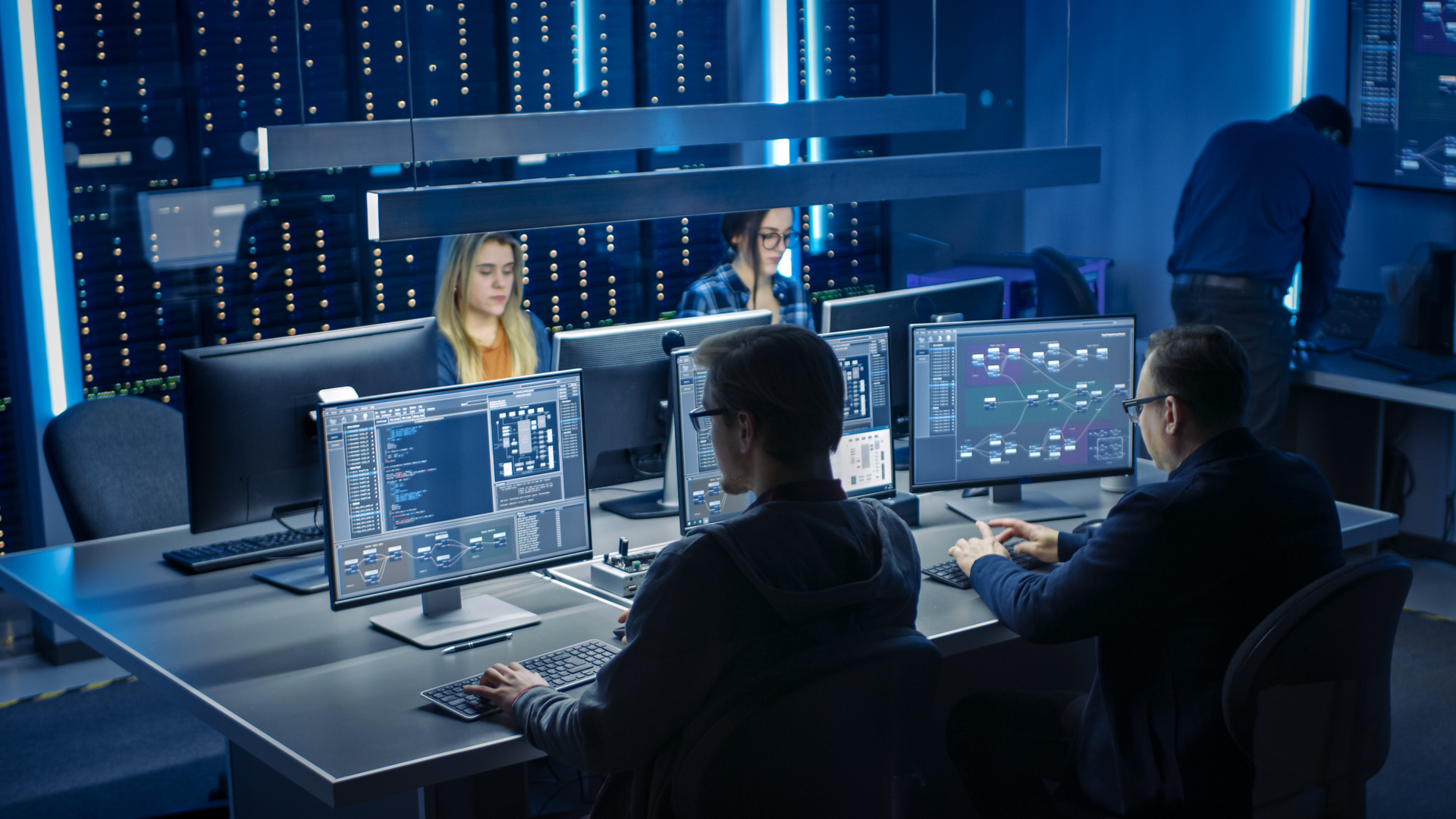 Team of IT Programers Working on Desktop Computers in Data Center System Control Room. Team of Young Professionals Working In Software and Hardware Development, Doing Coding