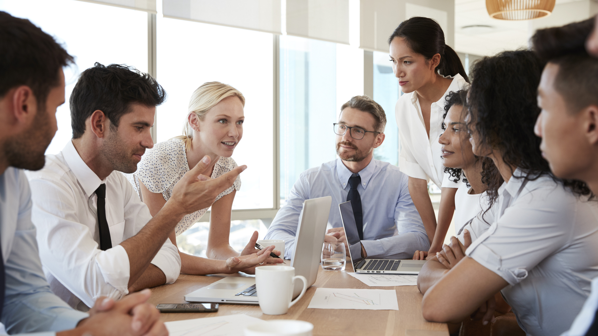 Group Of Businesspeople Meeting Around Table In Office