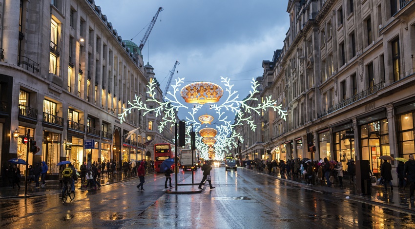 Christmas lights over a rainy street in London