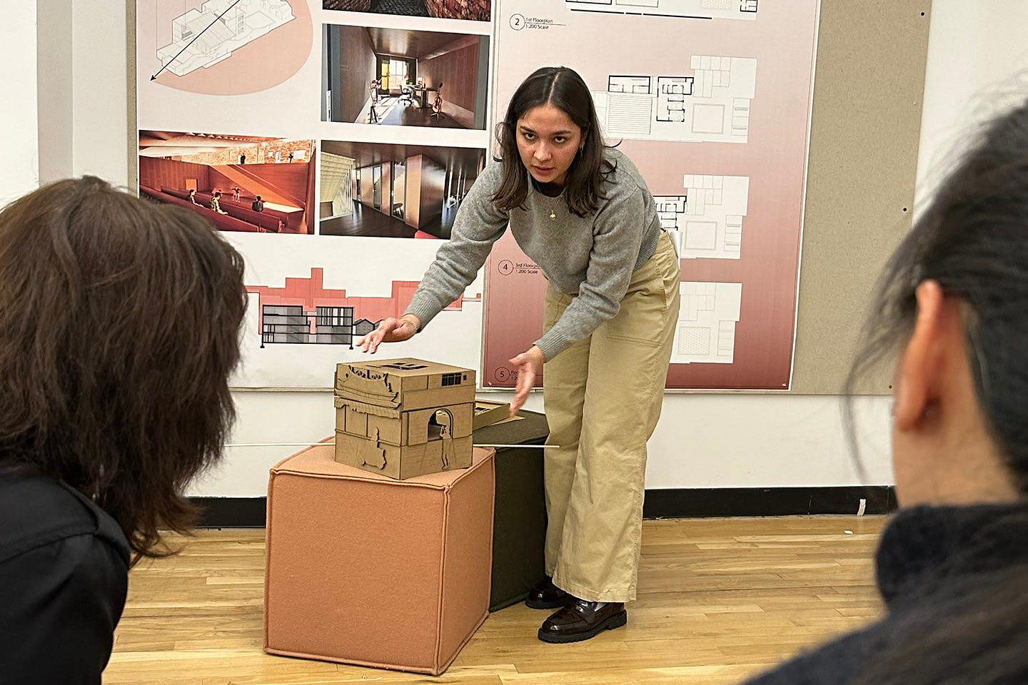 Valentina Aguerrevere Jiménez leans in front of her Soundscapes project, demonstrating its features to an audience during a presentation.