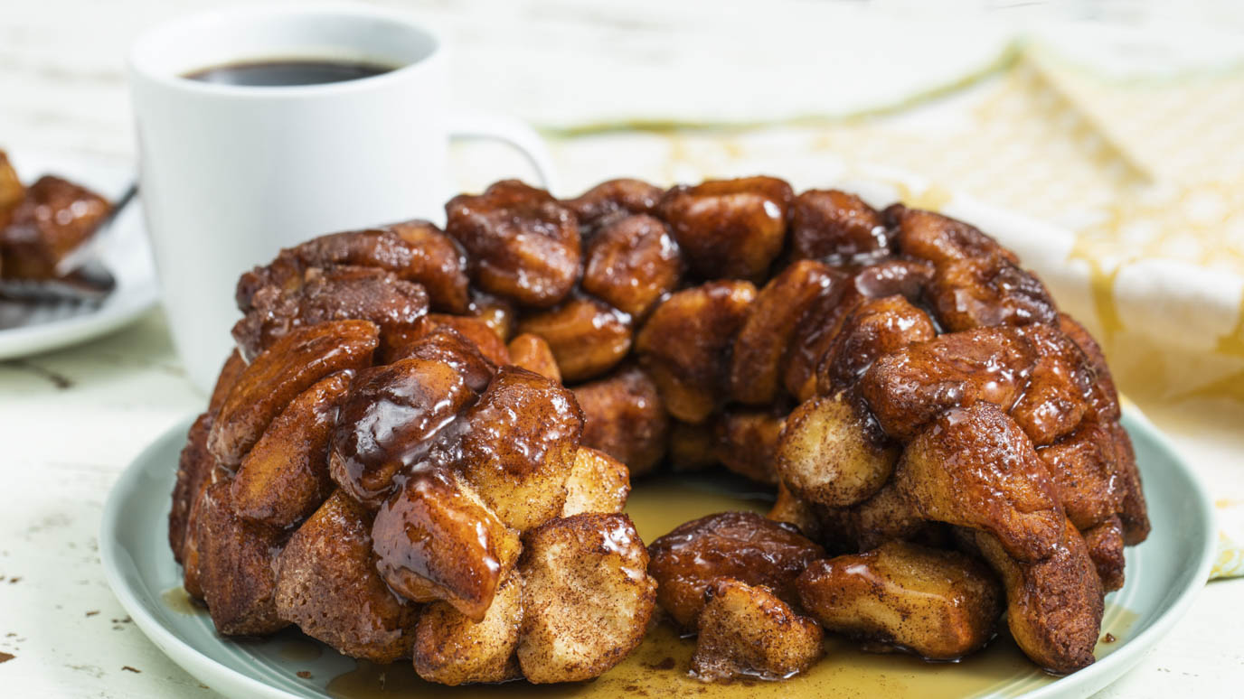 Cinnamon Monkey Bread on a Plate with a Cup of Coffee
