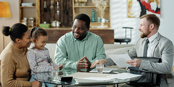 family with agent going over paperwork