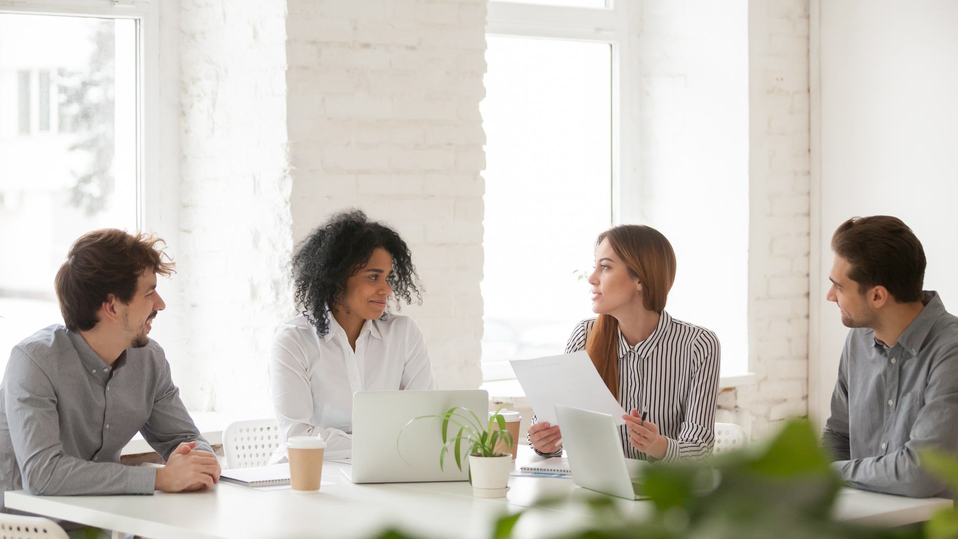 Multiracial male and female colleagues having discussion at team meeting