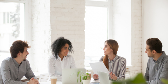 Multiracial male and female colleagues having discussion at team meeting