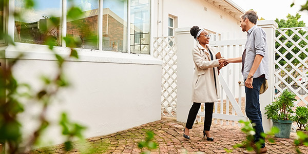 real estate agent shaking hands with homebuyer