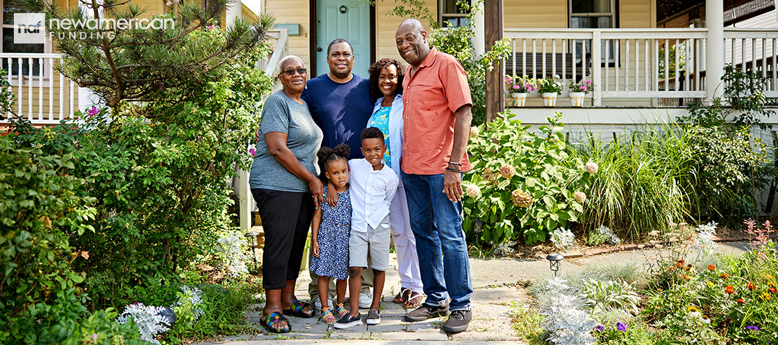 happy black family in front of their home