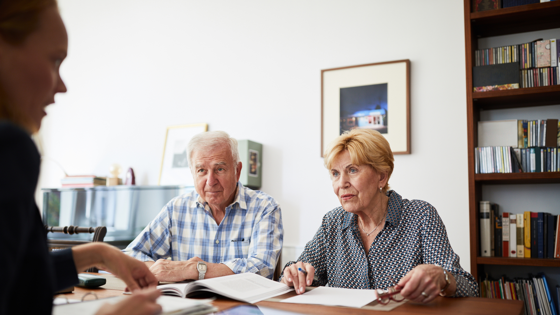 Senior couple meeting with financial consultant at home
