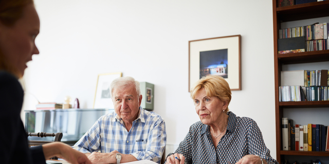 Senior couple meeting with financial consultant at home