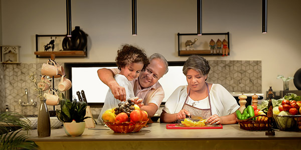 Grandparents cook with their grandchild in a nice kitchen