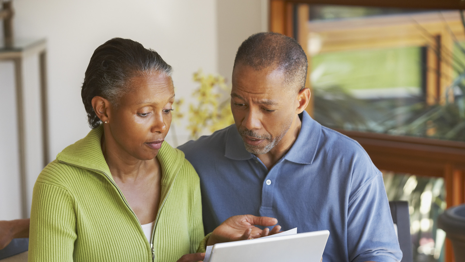 Senior African American couple paying bills