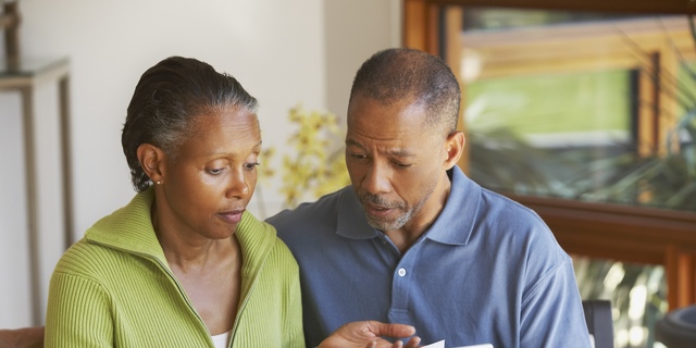 Senior African American couple paying bills