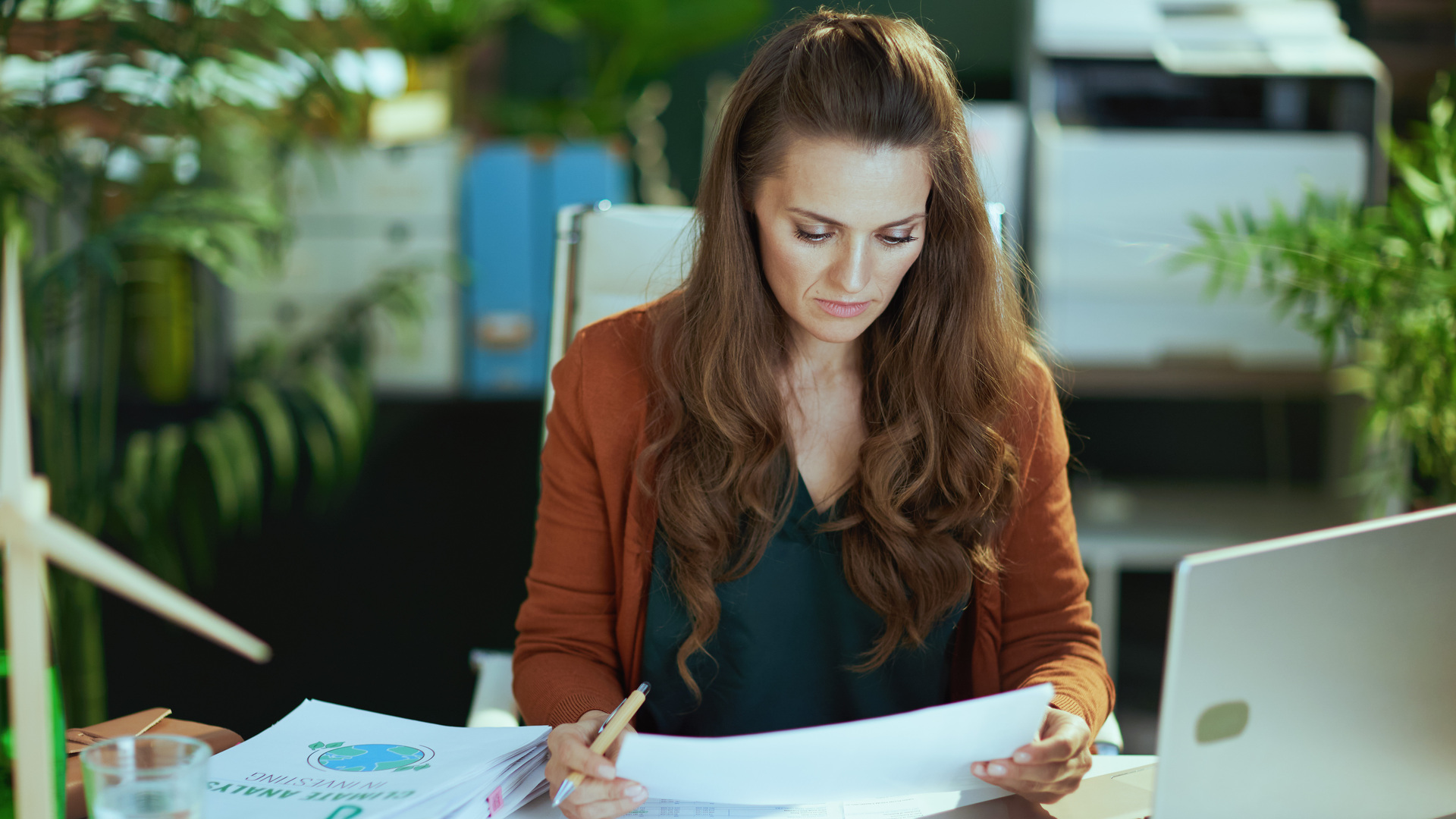 business owner woman in green office working with documents