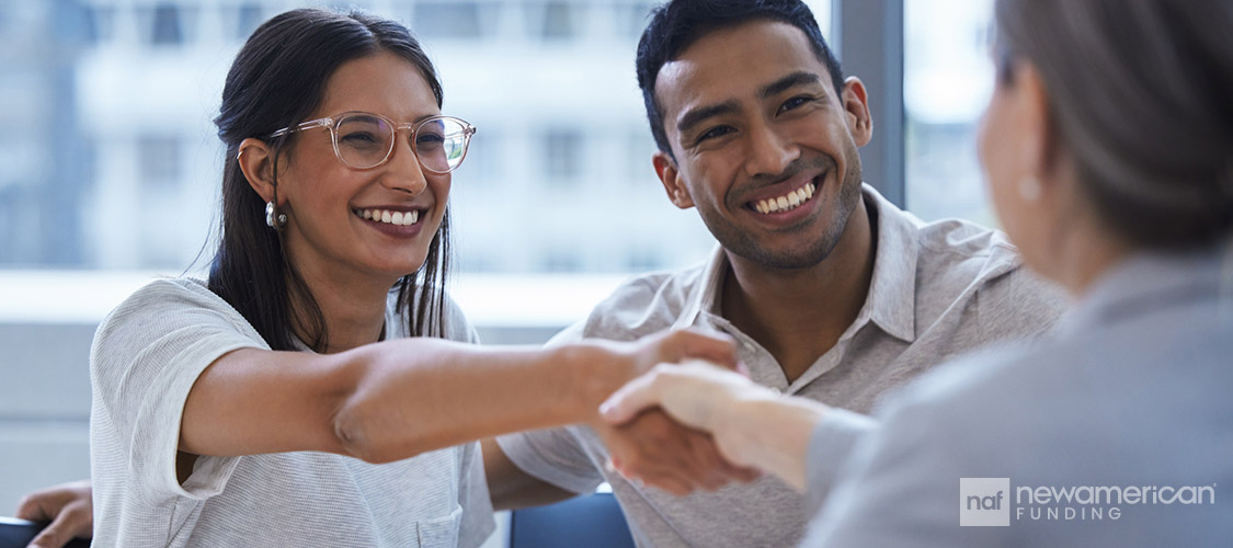 agent shaking hands with happy clients