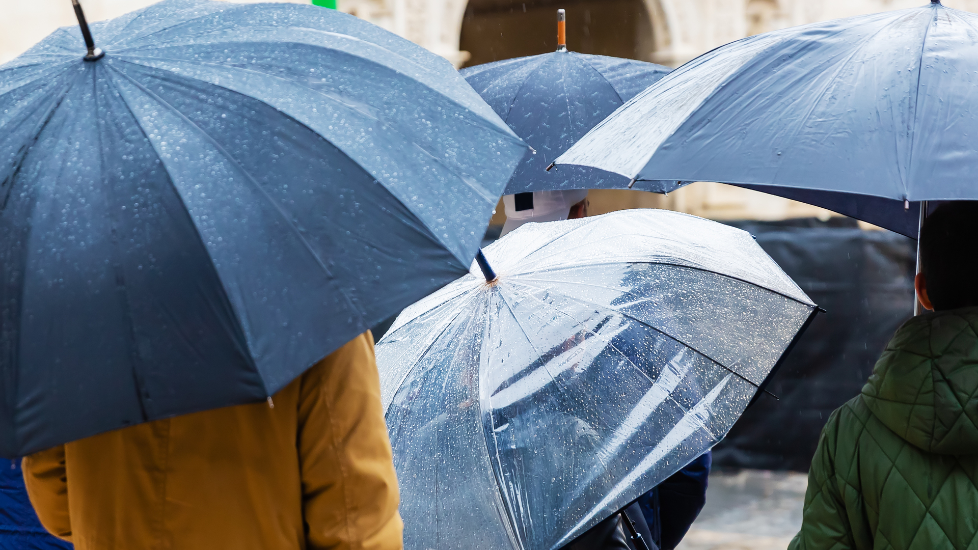 crowds of people with umbrellas in the city