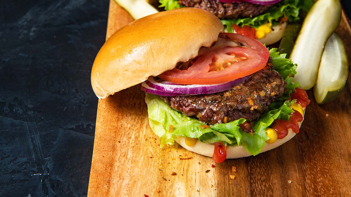 Burger topped with lettuce and tomato