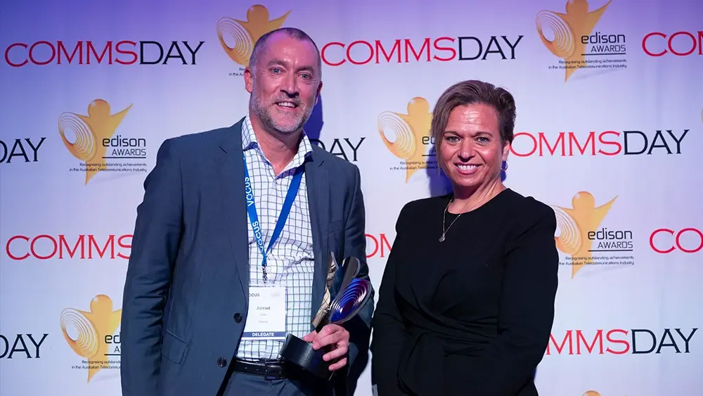 Picture of Jarrod Nink, Head of Vocus Wholesale accepting the award for Best Longhaul Network Operator at the Comms Day Edison Awards 2024