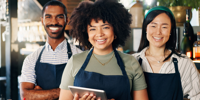 Diversity, restaurant and portrait of team at bar with manager, waiter and waitress at startup with digital app. Bistro, service barman and welcome, happy small business owner at cafe with tablet.