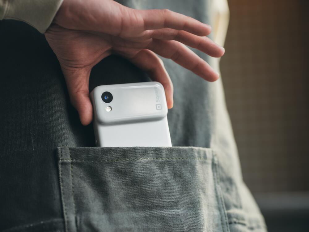 Restaurant employee holding Square Handheld in their pocket