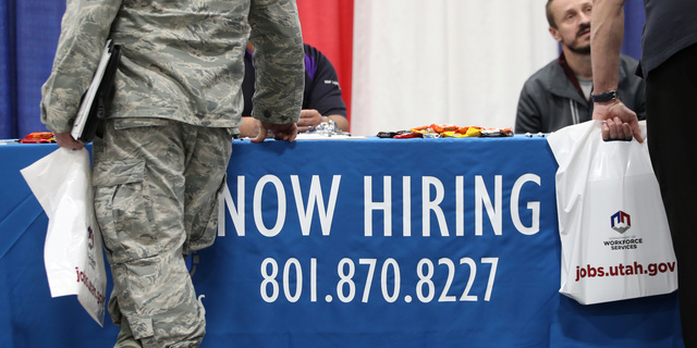 Veterans and military personnel discuss job opportunities at a military job fair in Sandy, Utah