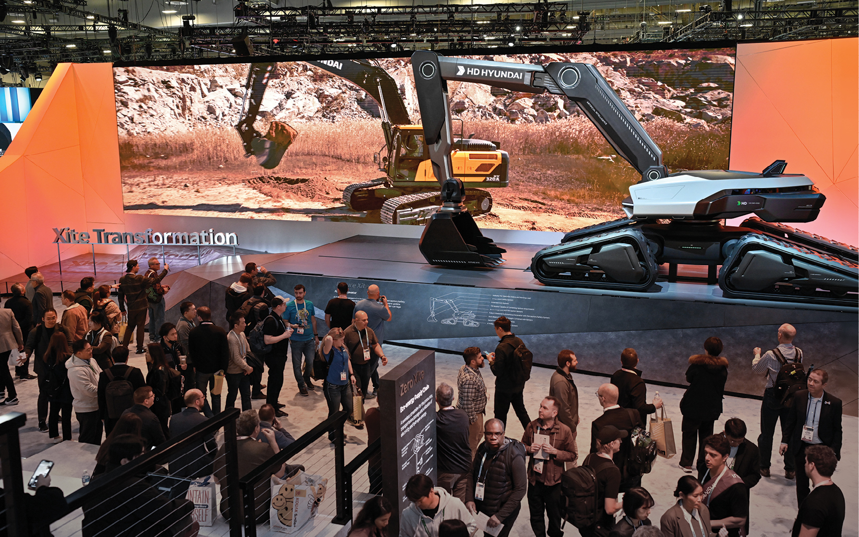 A futuristic excavator on display draws a crowd of visitors to the DEVELON exhibit at CES 2024.