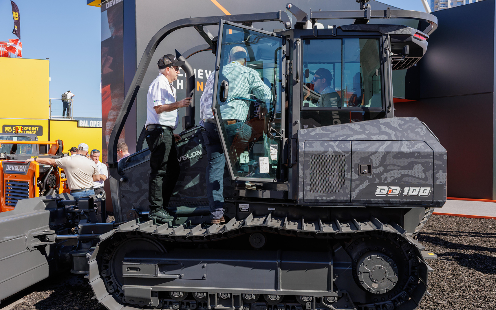 A camouflaged DD100 dozer on display at the DEVELON booth at CONEXPO 2026.