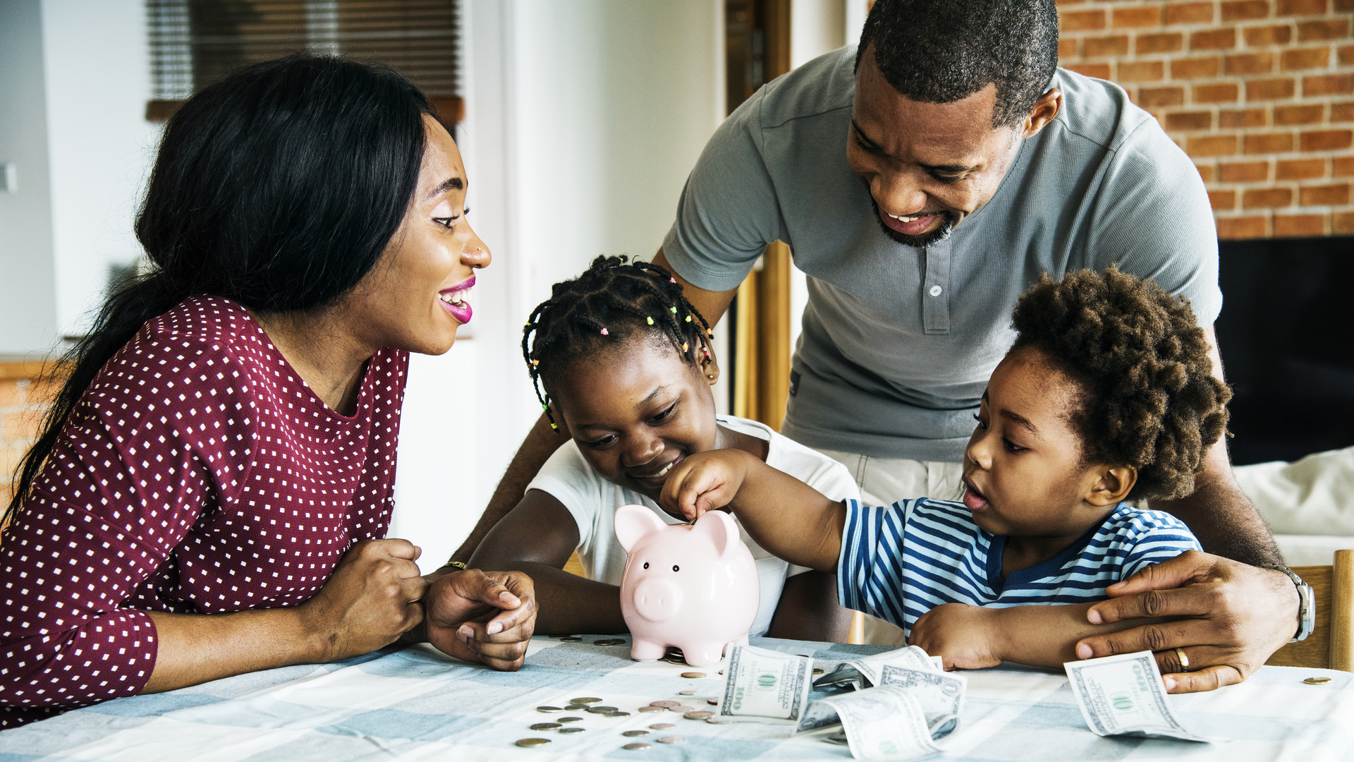 Family saving money to piggy bank