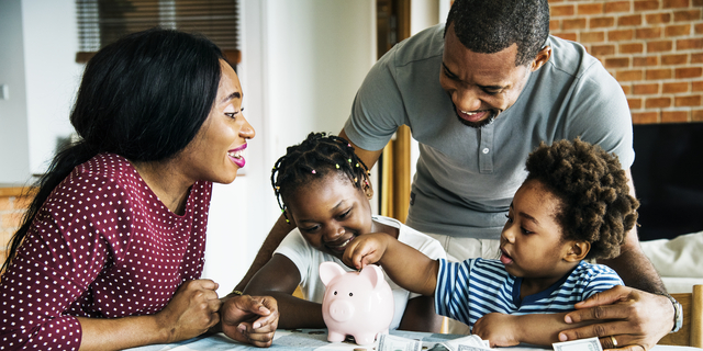 Family saving money to piggy bank