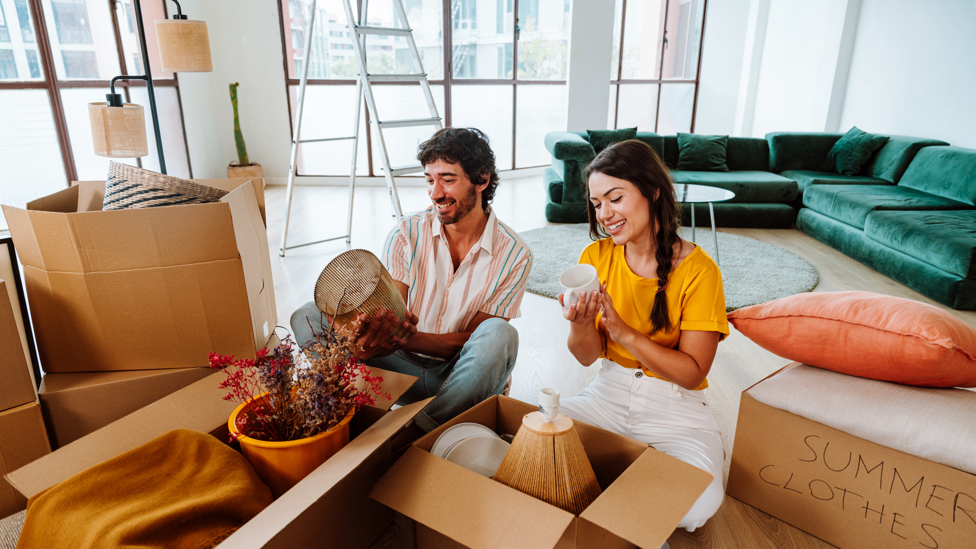 Happy young couple relocating in a new apartment.