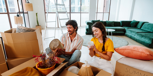 Happy young couple relocating in a new apartment.