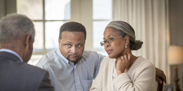 African American couple talking to businessman