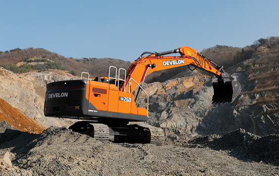 A DEVELON DX260LC-9 crawler excavator digging dirt on a job site.