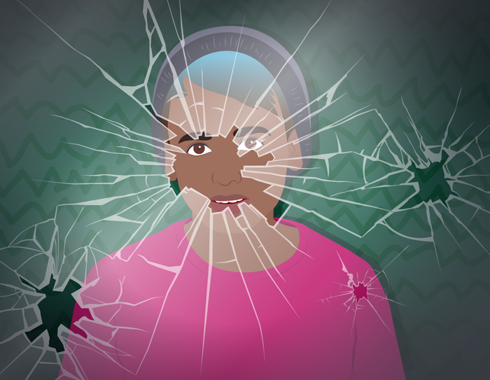 A young man peering out from behind shattered glass.