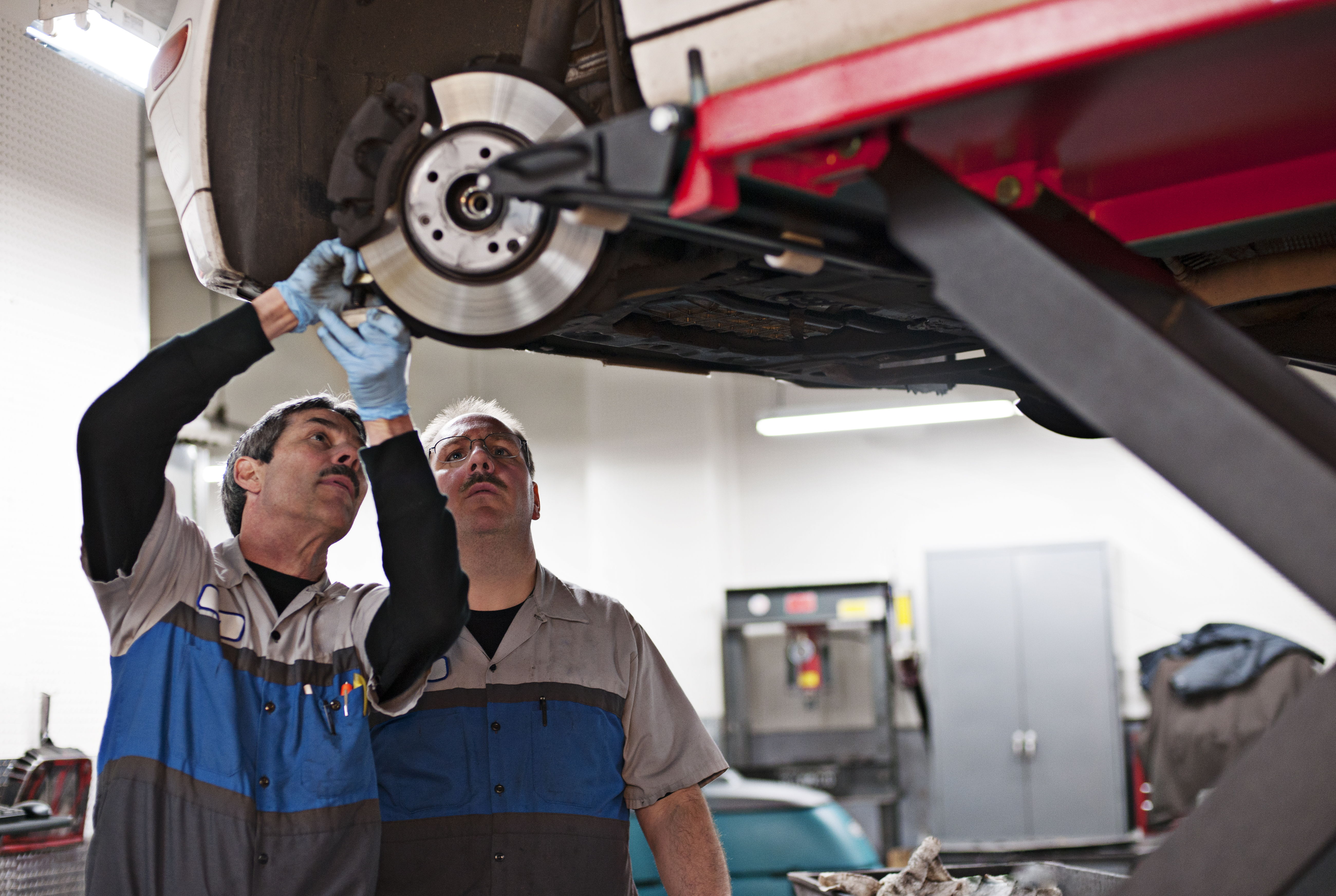 Two technicians engaged in a heavy equipment repair.