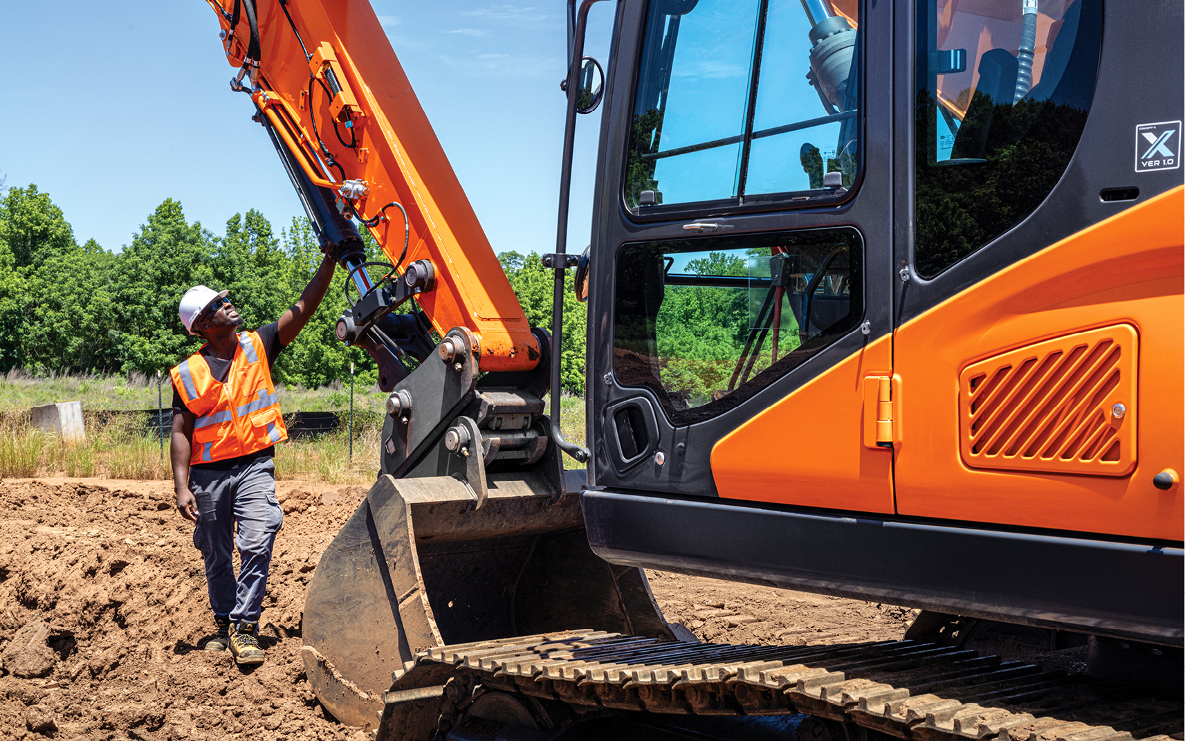 An operator following a heavy equipment maintenance schedule on a DEVELON excavator.