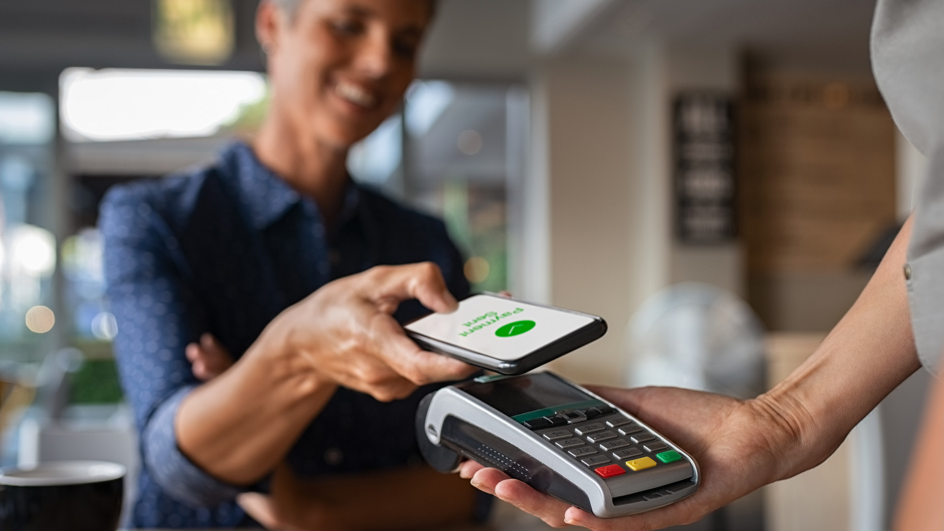Woman paying using NFC technology