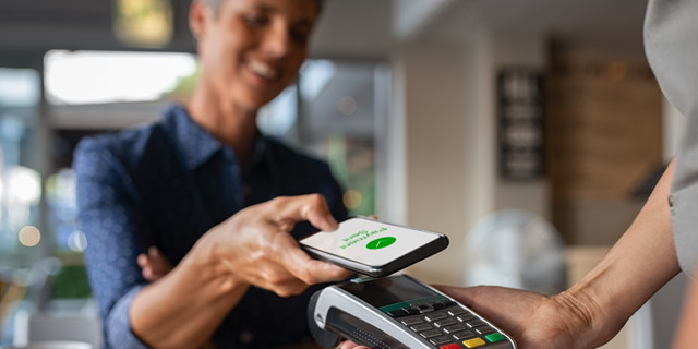 Woman paying using NFC technology