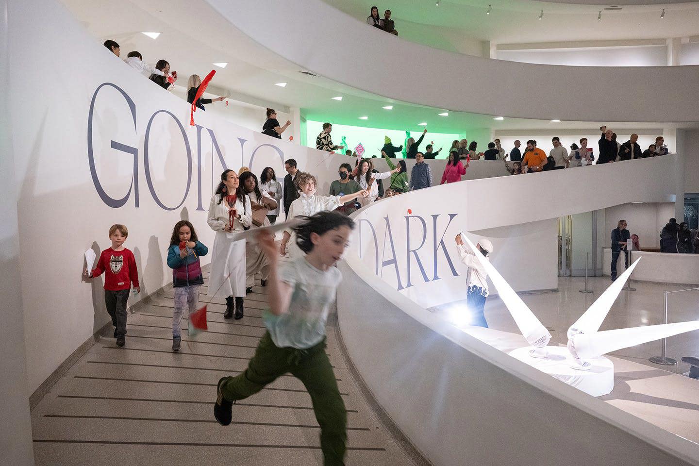 Children running through the spacious lobby and spiral ramp of the Guggenheim Museum.