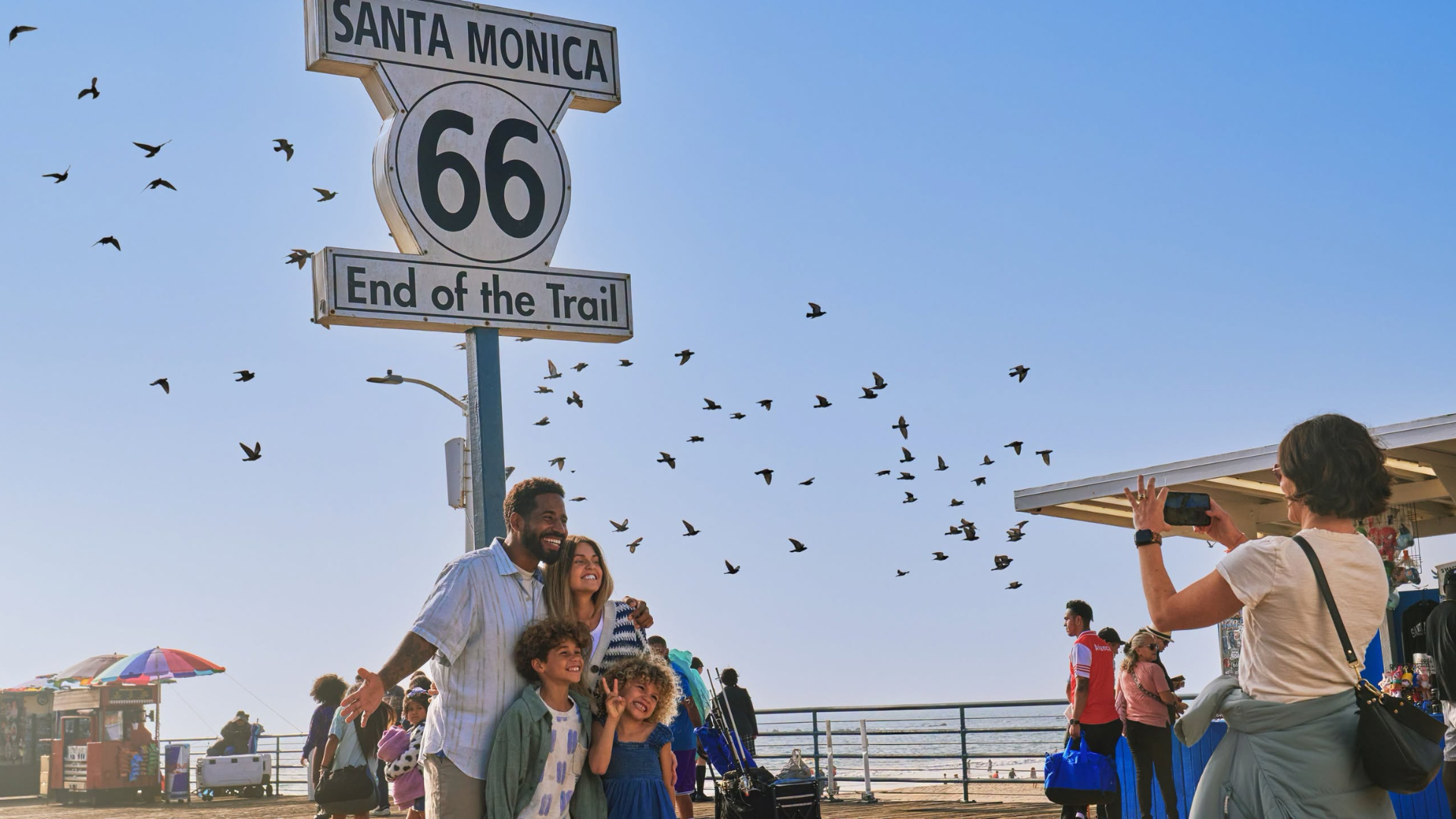 Image of family on holiday posing for a picture in Santa Monica