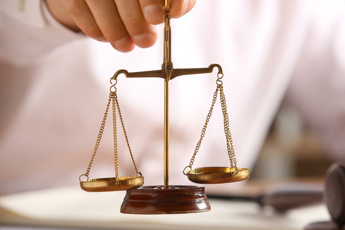 BICSI certification integrity concept featuring brass scales of justice