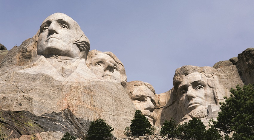 A view of Mount Rushmore looking up at it from below