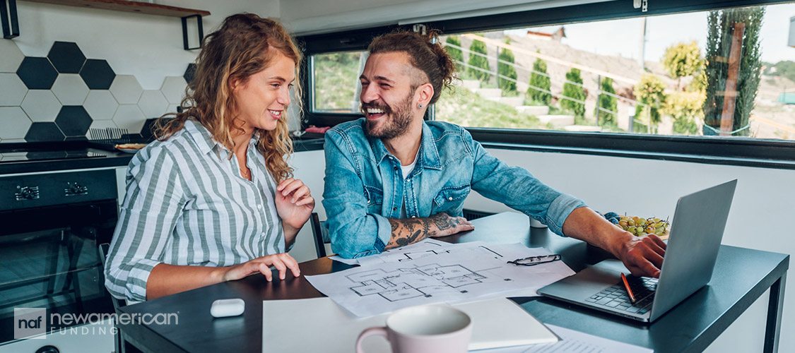 happy couple going over house plans