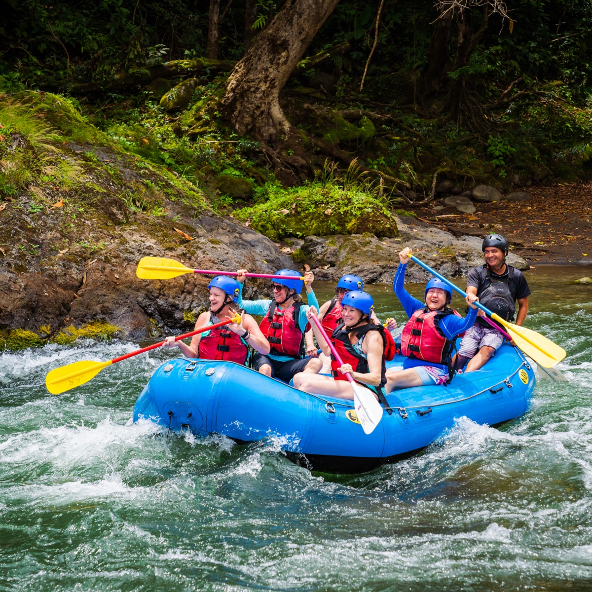 A group of Road Scholars gleefully white-water rafting in Costa Rica