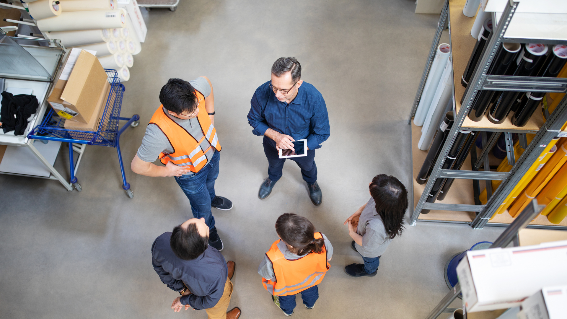 Warehouse manager talking to employees