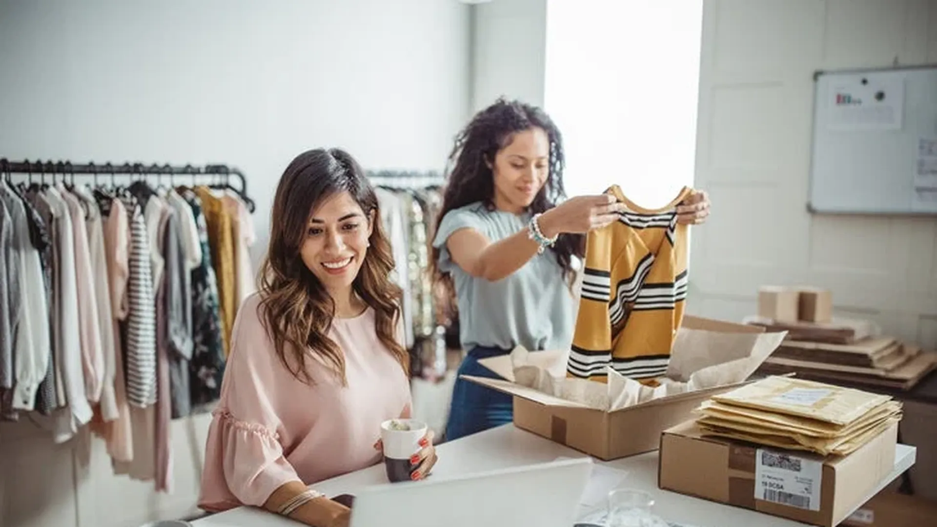 two_women_business_owners_packing_clothes_bA7qC0I.webp